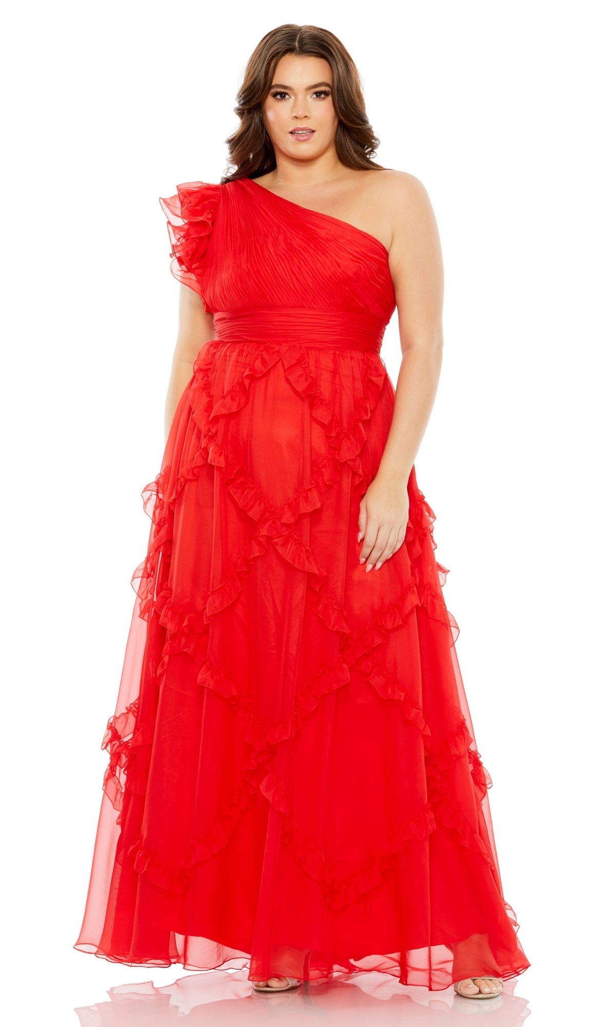 A woman wears the Long Plus-Size Formal Dress 68540 by Mac Duggal—a floor-length, one-shoulder red gown with ruffle details.